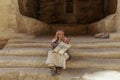 Little Petra, Jordan Ã¢â¬â June 20, 2017: Old Bedouin man or Arab man in traditional outfit, playing his musical instrument .